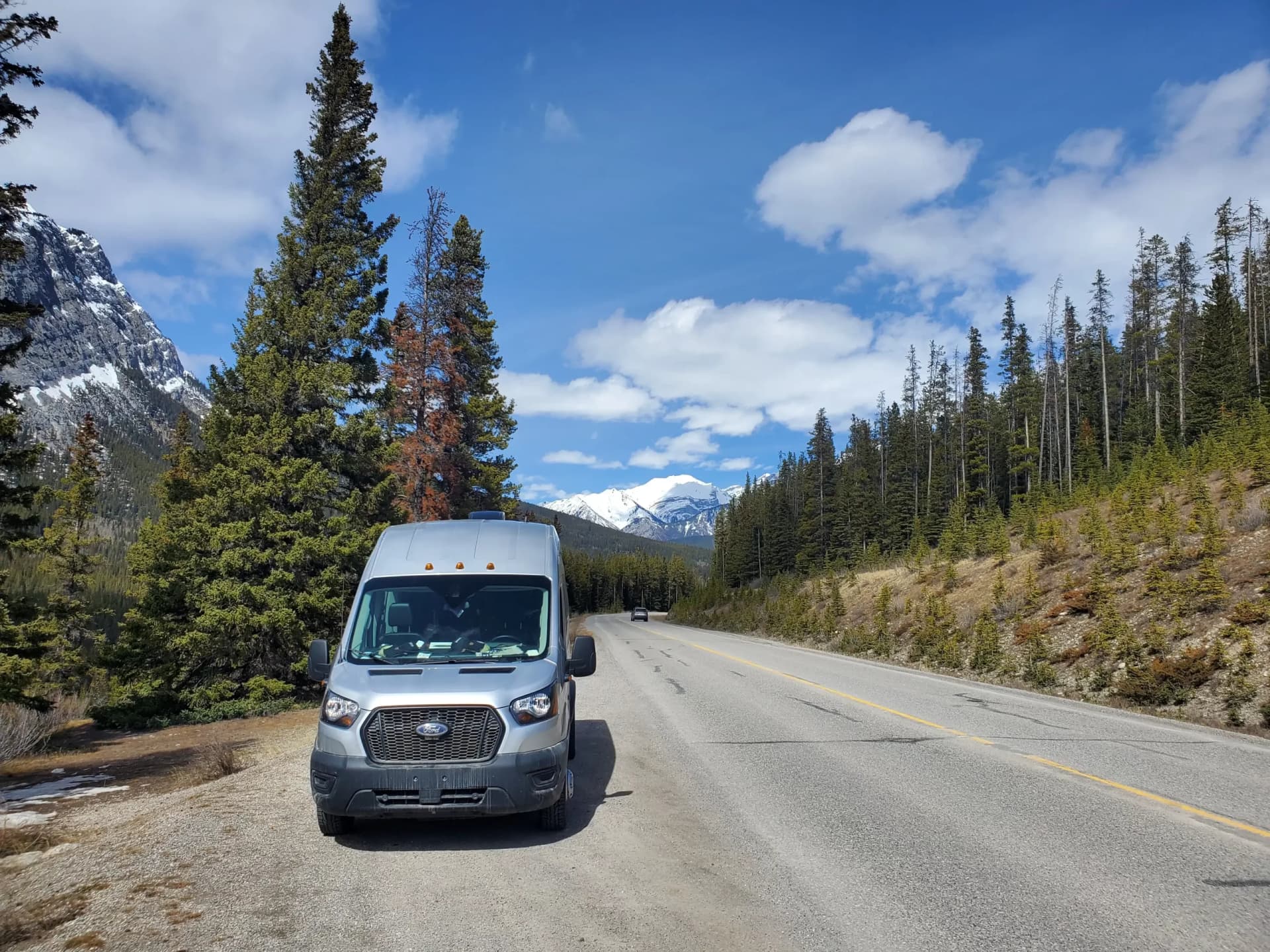 Reliable Campers Ford Transit camper van on a mountain road near Canmore in the Canadian Rockies